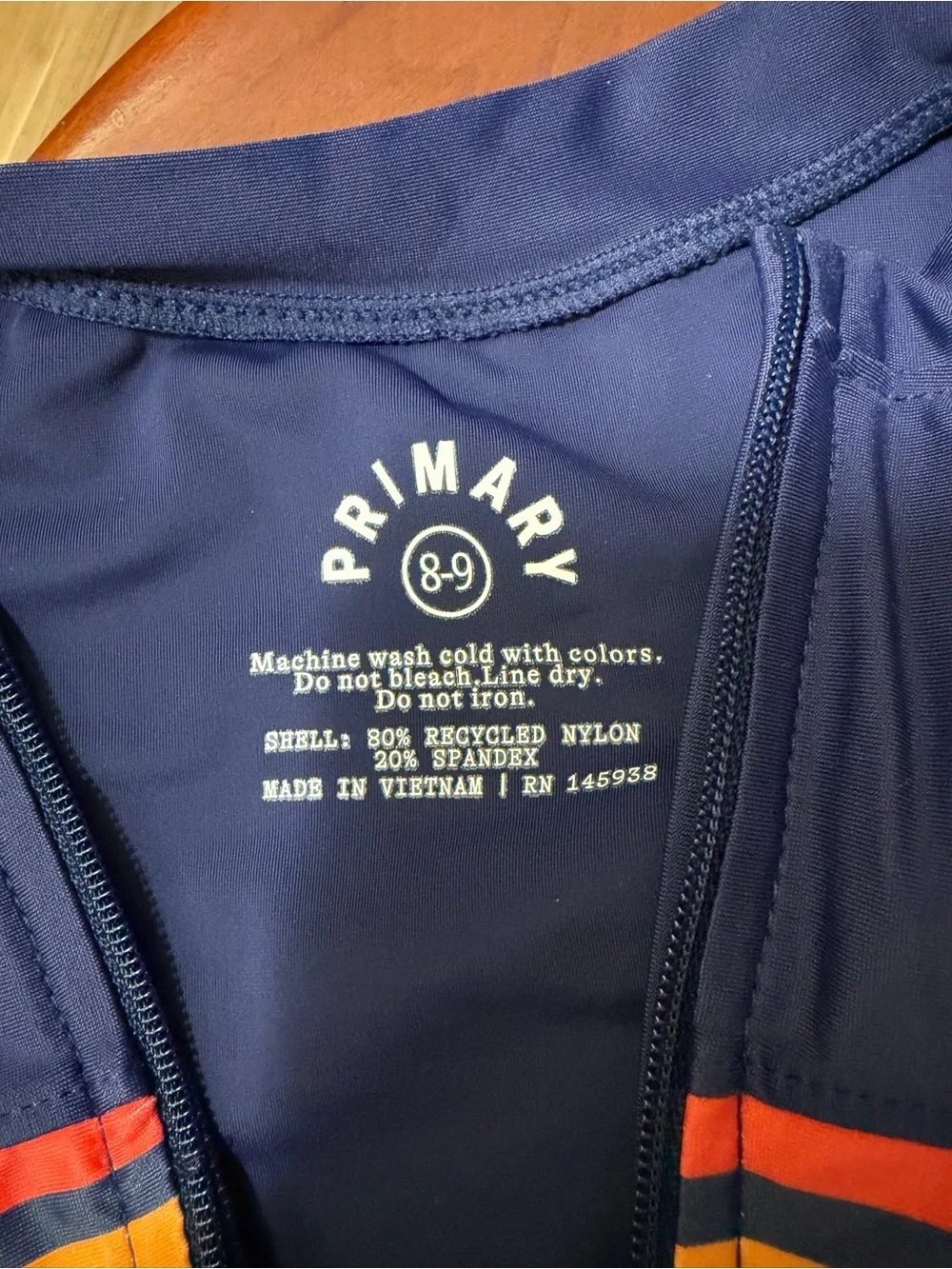Primary rainbow stripe navy rash guard